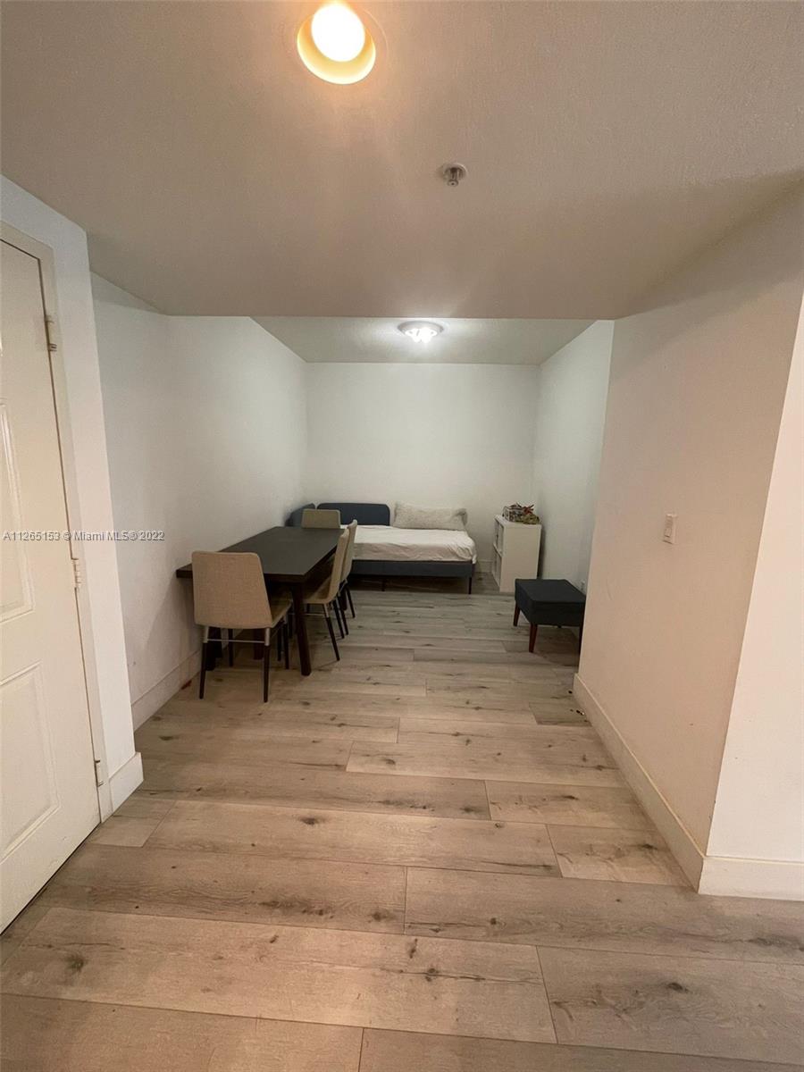4242 Northwest 2nd Street, Unit 708 Miami, FL 33126 - Photo 14 of 20 a living room with furniture and a rug