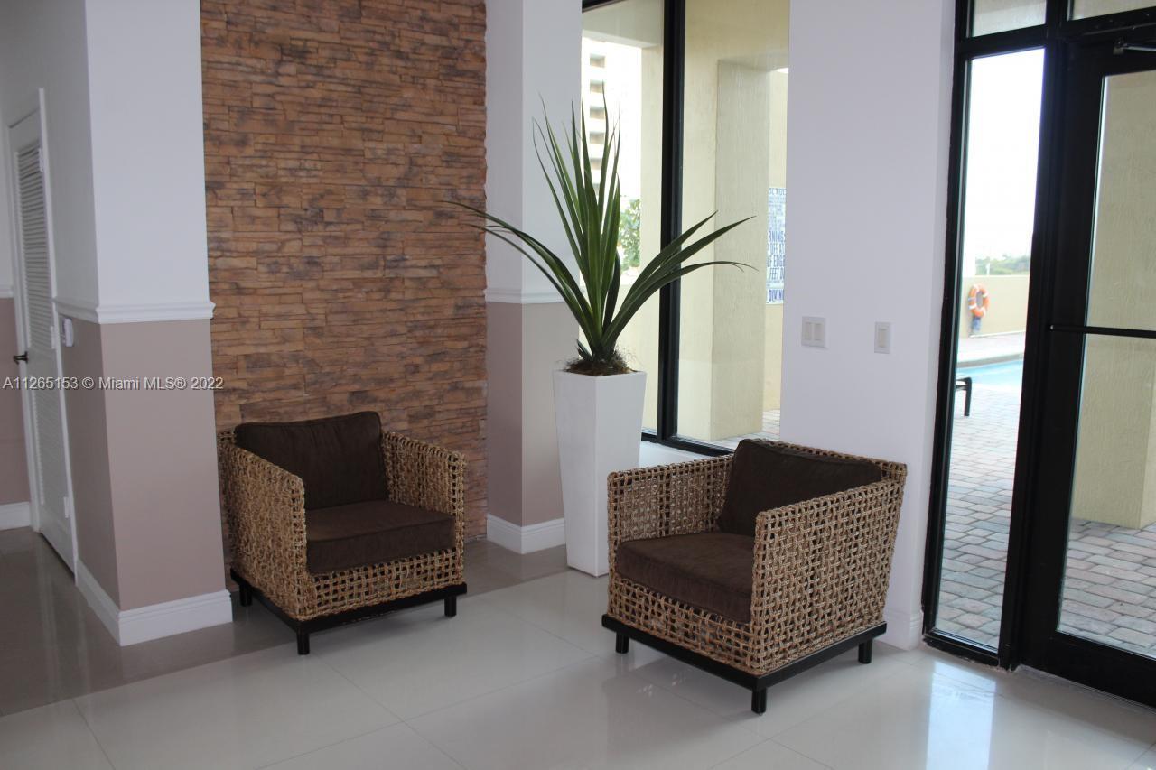 4242 Northwest 2nd Street, Unit 708 Miami, FL 33126 - Photo 17 of 20 a living room with furniture and a fireplace