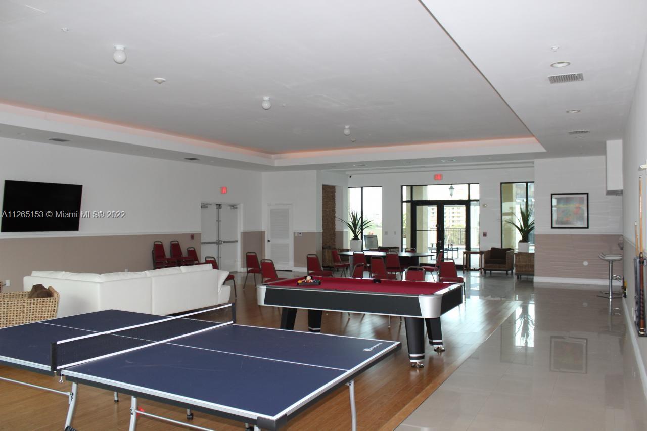 4242 Northwest 2nd Street, Unit 708 Miami, FL 33126 - Photo 18 of 20 a room with furniture pool table and windows