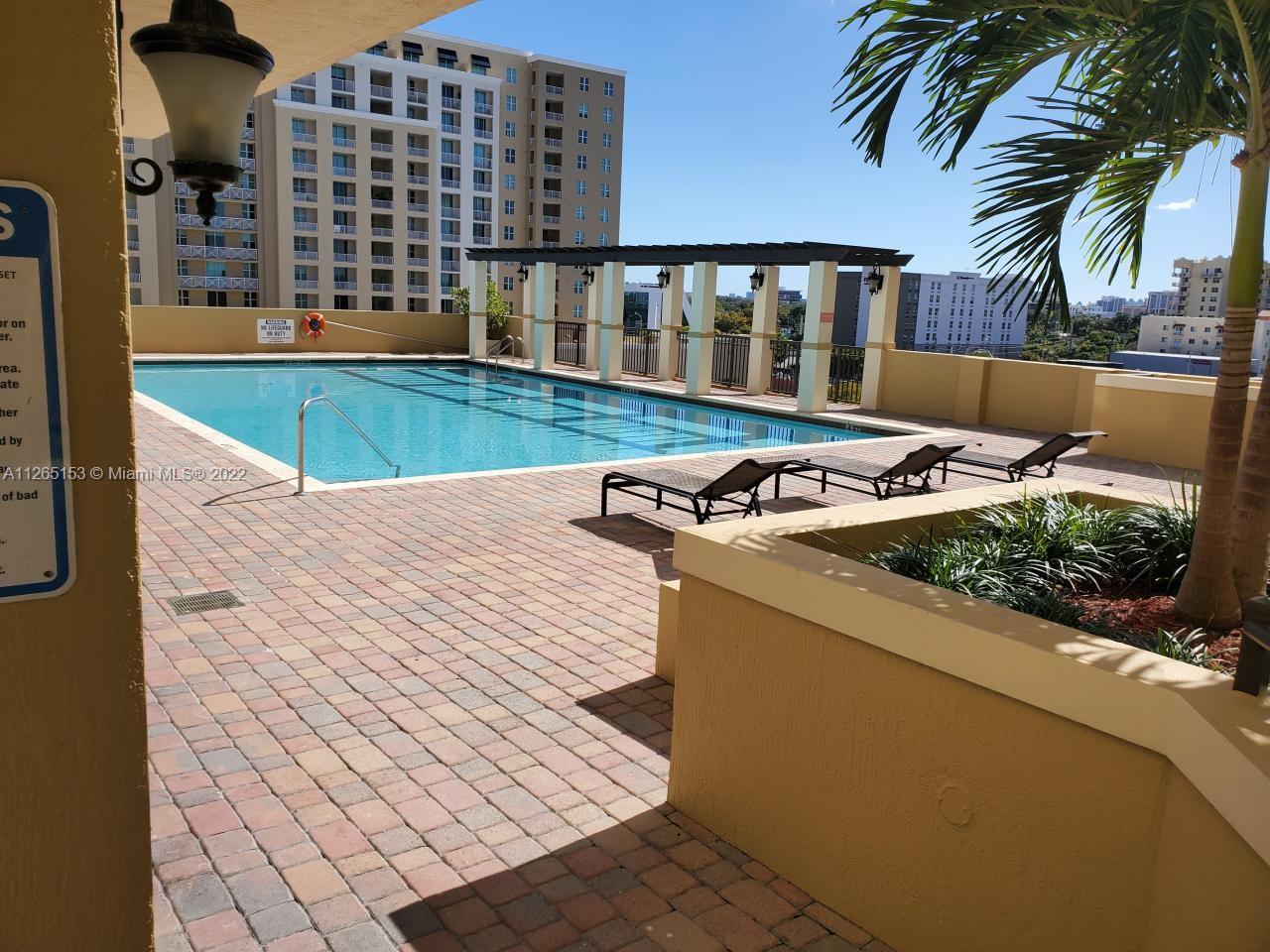 4242 Northwest 2nd Street, Unit 708 Miami, FL 33126 - Photo 19 of 20 swimming pool view with a outdoor seating
