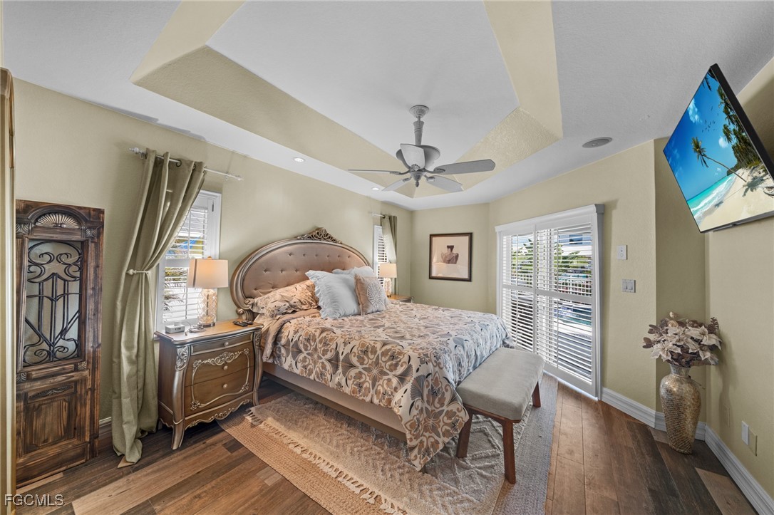 12234 Boat Shell Drive Matlacha Isles, FL 33991 - Photo 16 of 50 a bedroom with a large bed and a flat tv screen on dresser