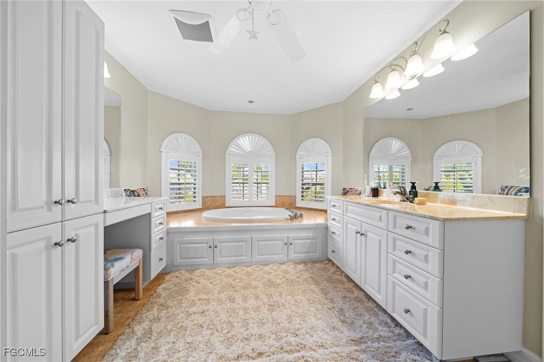 12234 Boat Shell Drive Matlacha Isles, FL 33991 - Photo 18 of 50 a large bathroom with a double vanity sink a mirror and a shower