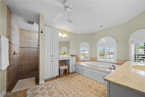 a bedroom with a bed couch and a window