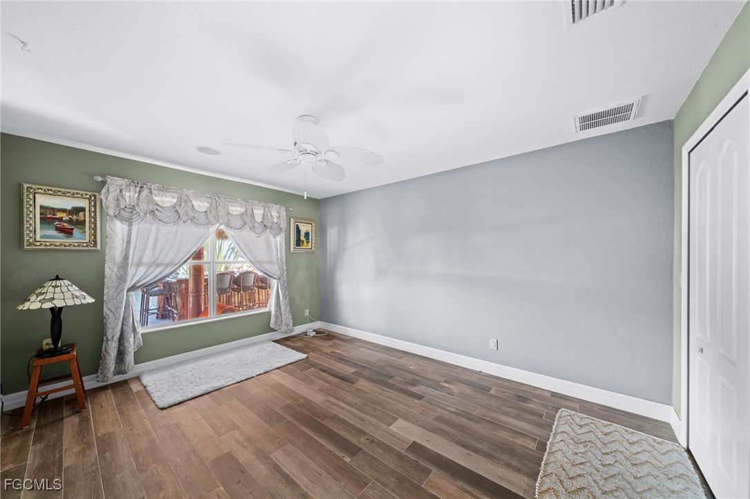 12234 Boat Shell Drive Matlacha Isles, FL 33991 - Photo 22 of 50 a view of an empty room with window and wooden floor