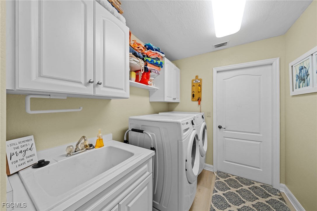 12234 Boat Shell Drive Matlacha Isles, FL 33991 - Photo 23 of 50 a utility room with dryer and washer