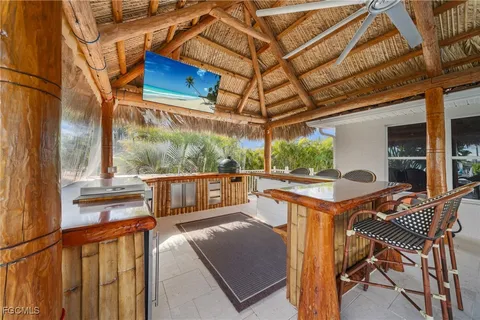 a kitchen with stainless steel appliances granite countertop a sink a stove and a wooden cabinets