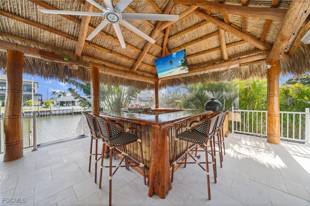 12234 Boat Shell Drive Matlacha Isles, FL 33991 - Photo 33 of 50 a table and chairs in patio with a fireplace