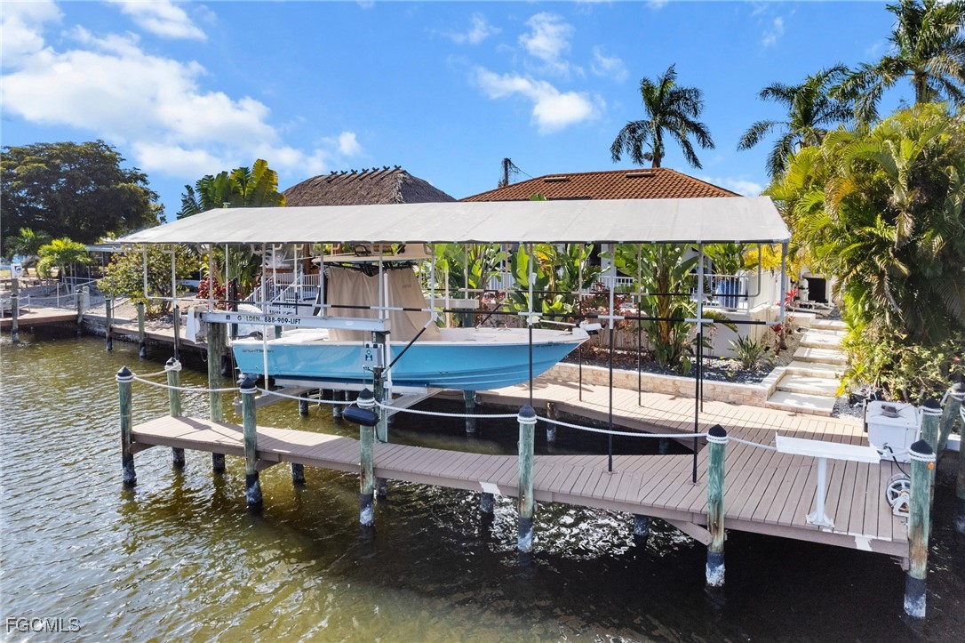 12234 Boat Shell Drive Matlacha Isles, FL 33991 - Photo 34 of 50 a view of a patio with a table and chairs under an umbrella