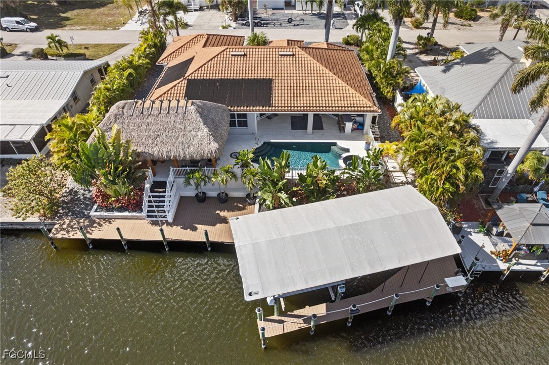 12234 Boat Shell Drive Matlacha Isles, FL 33991 - Photo 35 of 50 an aerial view of a house with swimming pool and large trees