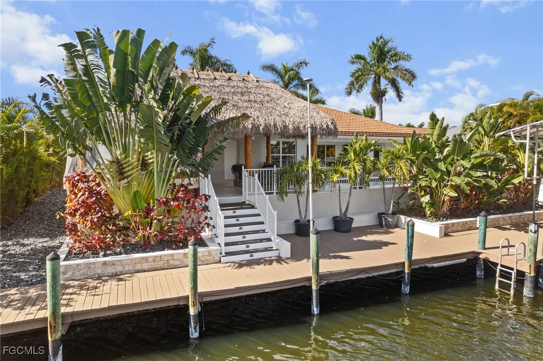 12234 Boat Shell Drive Matlacha Isles, FL 33991 - Photo 36 of 50 a view of a swimming pool with a table and chairs