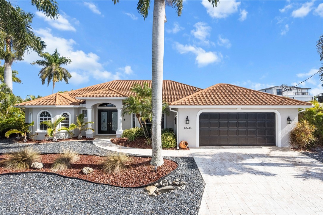 12234 Boat Shell Drive Matlacha Isles, FL 33991 - Photo 38 of 50 a front view of a house with a yard and potted plants