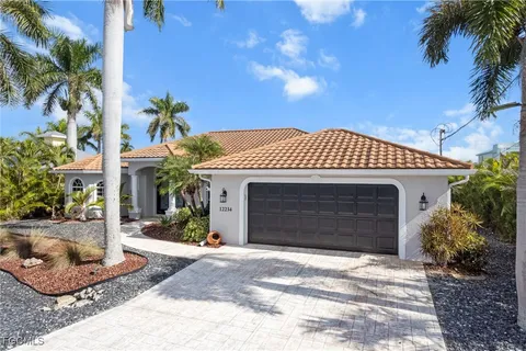 an aerial view of a house with outdoor seating a lake view