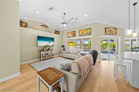 a living room with furniture a flat screen tv and a table