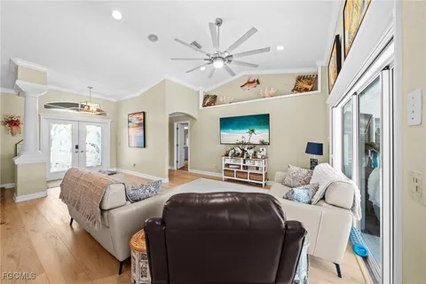 a bedroom with furniture and a large window