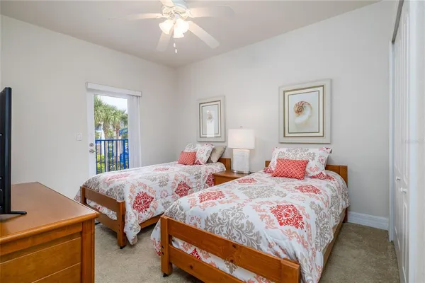 a bedroom with two beds and a chandelier