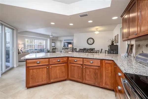 a large kitchen with granite countertop a sink and dishwasher in it