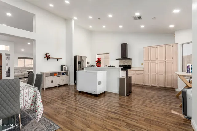 a kitchen that has a lot of cabinets a sink and a wooden floor in it
