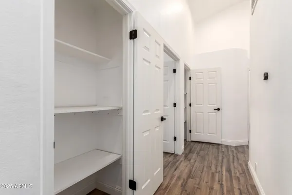 a view of a room with wooden floor