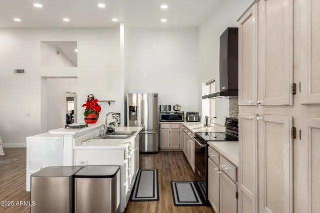 a kitchen with a sink a stove and cabinets