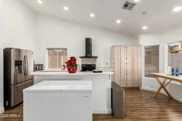 a kitchen with a refrigerator and a stove