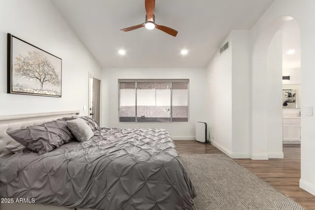 a bedroom with a large bed and a window