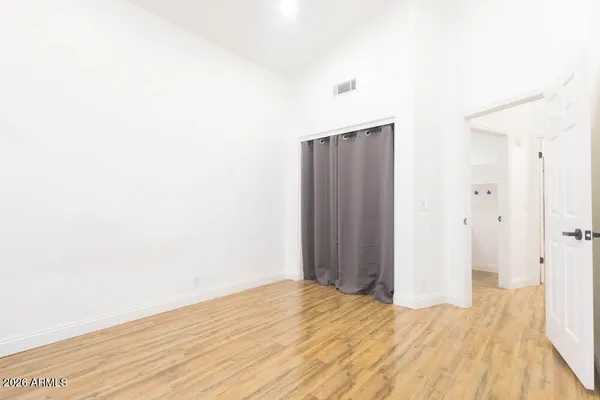 a view of a hallway with wooden floor