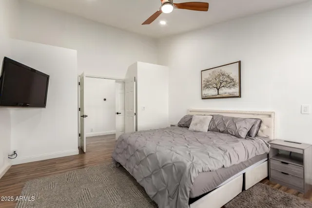 a bedroom with a bed and a flat screen tv