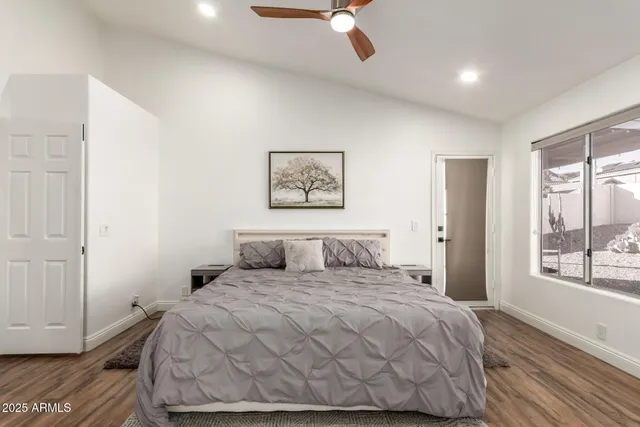 a bedroom with a large bed and a window