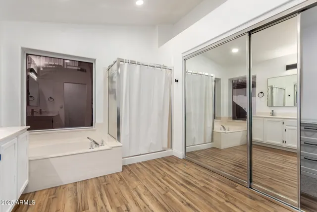 a bathroom with a bathtub and a shower