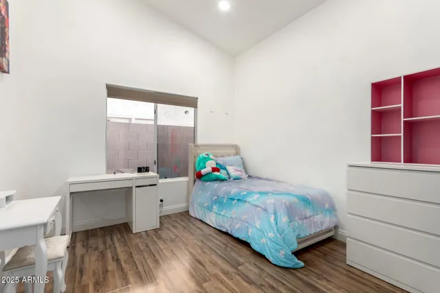 a bedroom with a bed and a table