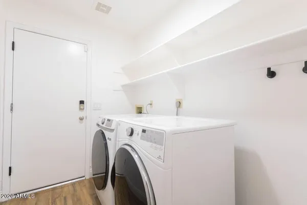 a backyard of a house with barbeque oven table and chairs