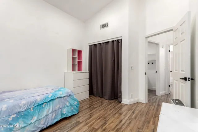 a bedroom with a bed and a mirror