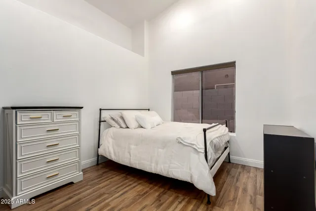 a bedroom with a bed and a window