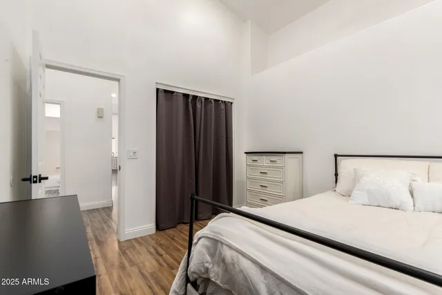 a bedroom with a bed and mirror