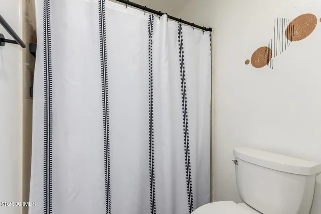 a bathroom with a shower curtain