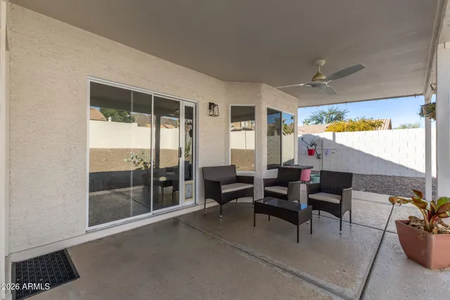 a dining room with furniture and a floor to ceiling window
