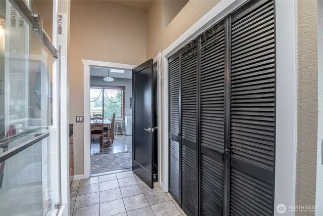 a view of a hallway with dining room and kitchen view