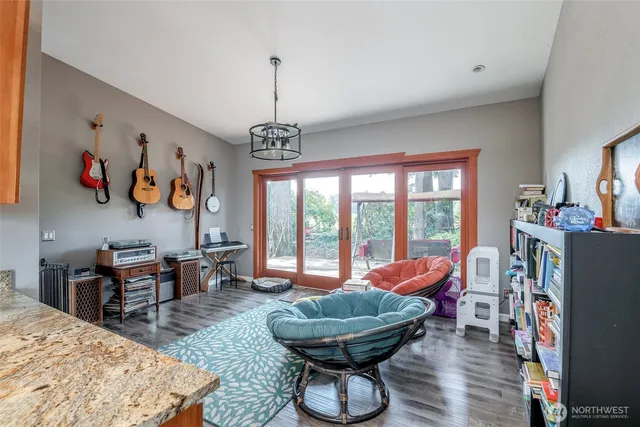 a living room with furniture and a chandelier