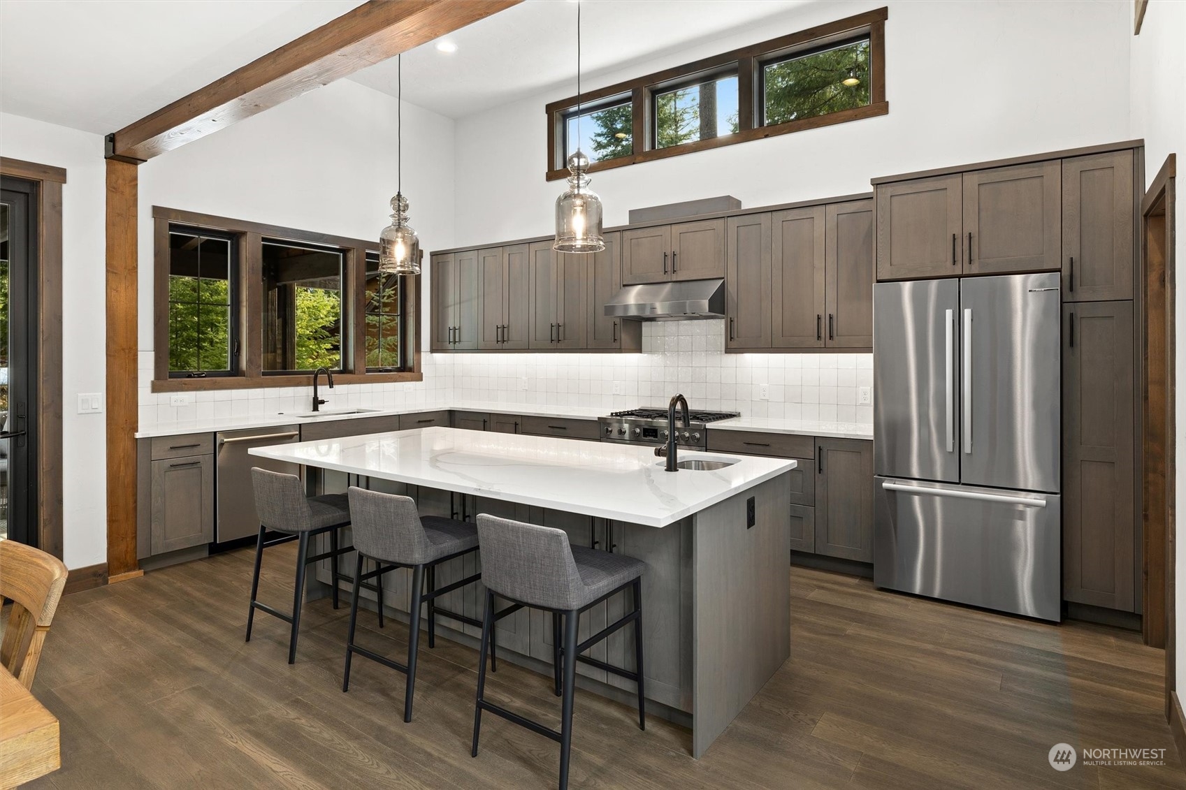 1810 Larkspur Loop Cle Elum, WA 98922 - Photo 18 of 35 a kitchen with stainless steel appliances granite countertop a table chairs and a refrigerator