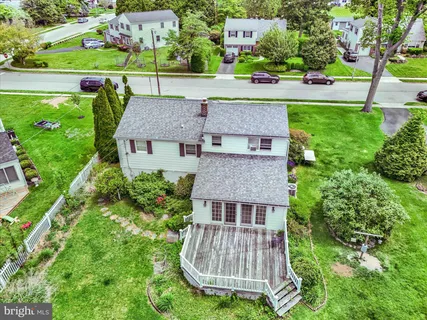 an aerial view of a house with garden space and street view