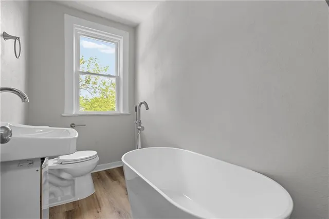 a white bath tub sitting next to a white toilet
