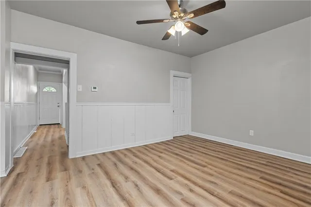 a view of empty room with wooden floor