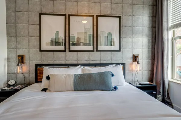 a bedroom with a bed and a mirror