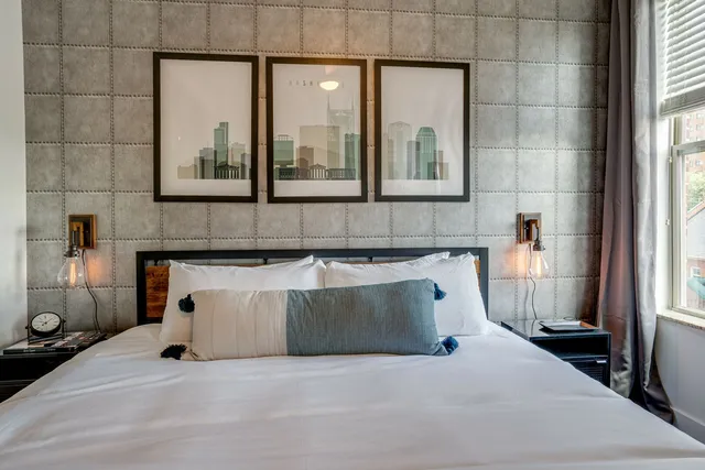 a bedroom with a bed and a mirror