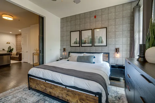 a bedroom with a bed and a large window