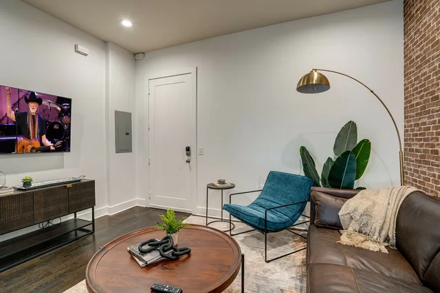 a living room with furniture and wooden floor