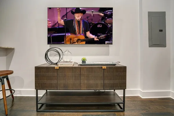 a kitchen with stainless steel appliances kitchen island a table chairs in it and wooden floors