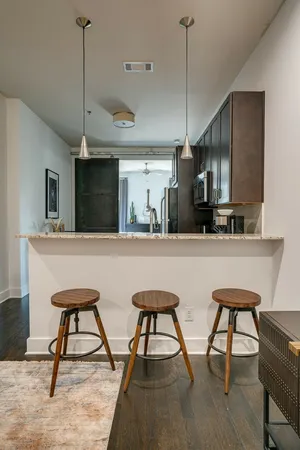 a kitchen with stainless steel appliances kitchen island a chandelier