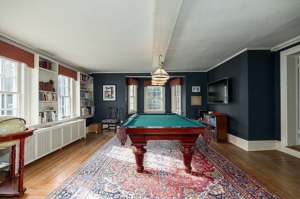 13 Main Street Boxford, MA 01921 - Photo 15 of 36 a living room with furniture a flat screen tv and large window