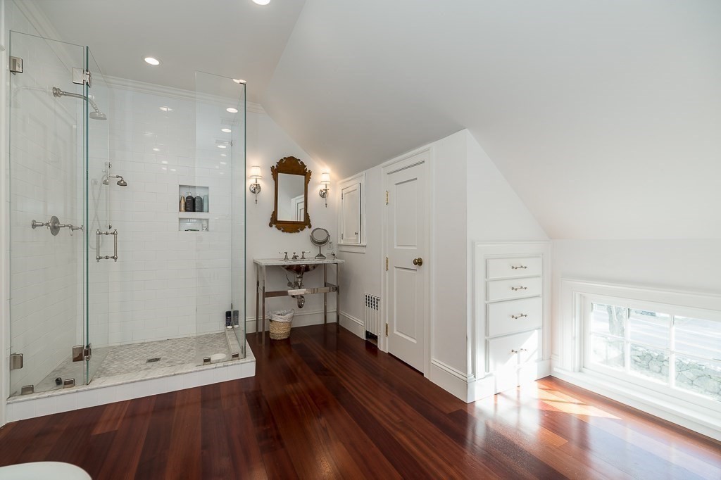 13 Main Street Boxford, MA 01921 - Photo 19 of 36 a bathroom with a glass door shower a sink and a mirror